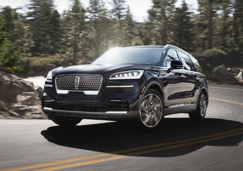 A Lincoln Aviator® SUV is being driven on a winding mountain road | Boulevard Lincoln in Georgetown DE