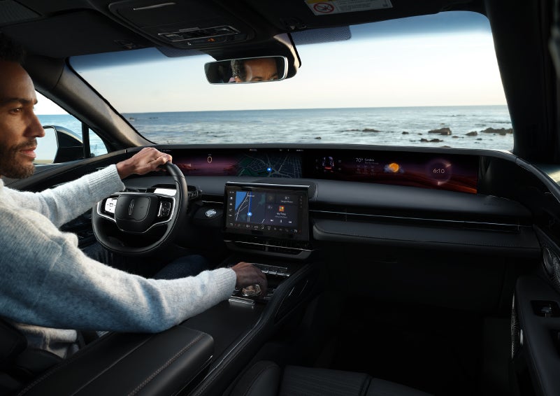 A driver of a parked 2024 Lincoln Nautilus® SUV takes a relaxing moment at a seaside overlook while inside his Nautilus. | Boulevard Lincoln in Georgetown DE
