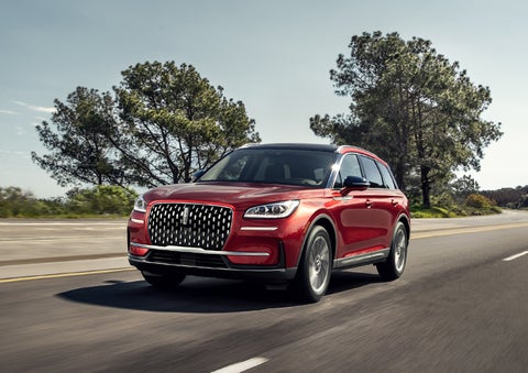 A 2023 Lincoln Corsair® SUV is shown being driven on a country road. | Boulevard Lincoln in Millsboro DE