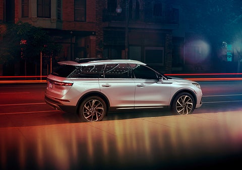 A 2023 Lincoln Corsair® SUV is shown parked in the city at night. | Boulevard Lincoln in Millsboro DE
