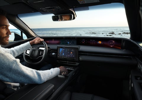A driver of a parked 2025 Lincoln Nautilus® SUV takes a relaxing moment at a seaside overlook while inside his Nautilus. | Boulevard Lincoln in Millsboro DE