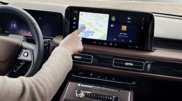 A person is tapping the center display touchscreen of a 2026 Lincoln Aviator® SUV. | Boulevard Lincoln in Millsboro DE