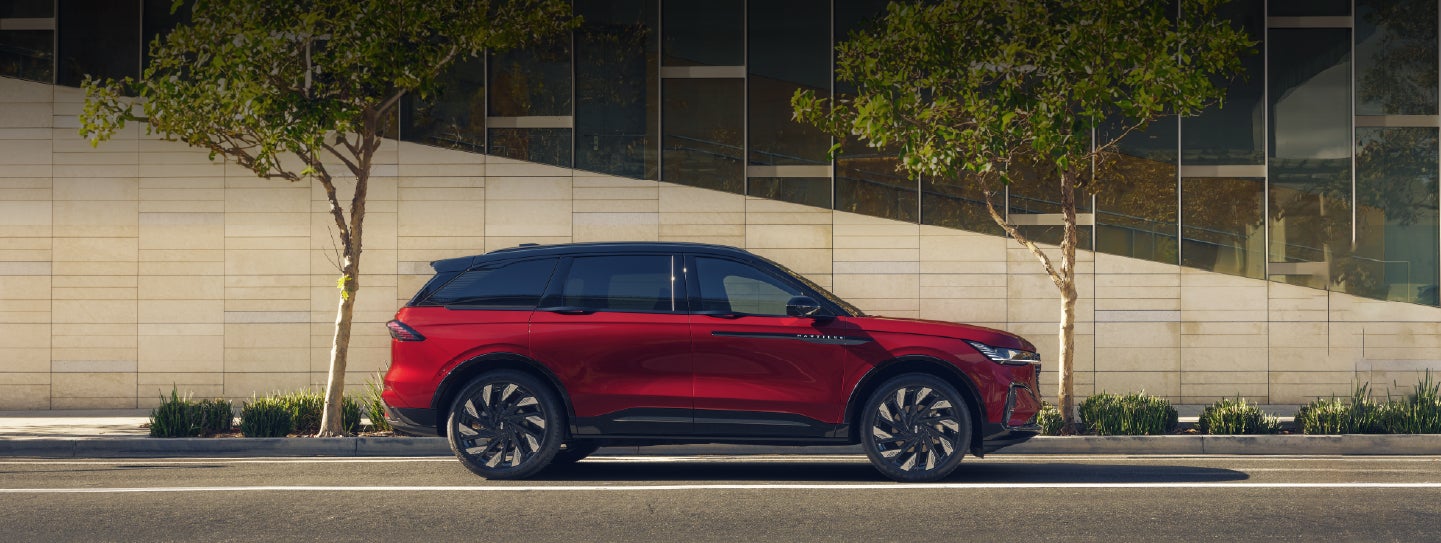 A 2026 Lincoln Nautilus® SUV with an available Hybrid Powertrain is parked in an urban setting. | Boulevard Lincoln in Millsboro DE
