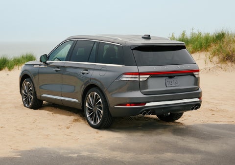 A 2027 Lincoln Aviator® SUV is parked next to sand dunes. | Boulevard Lincoln in Millsboro DE