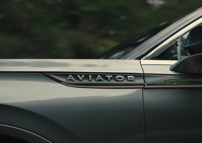 The driver’s side door and fender badging of a gray 2027 Lincoln Aviator® SUV are showcased. | Boulevard Lincoln in Millsboro DE