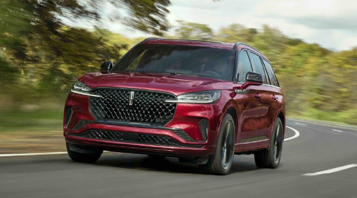 A 2027 Lincoln Aviator® SUV is being driven on a country road | Boulevard Lincoln in Millsboro DE