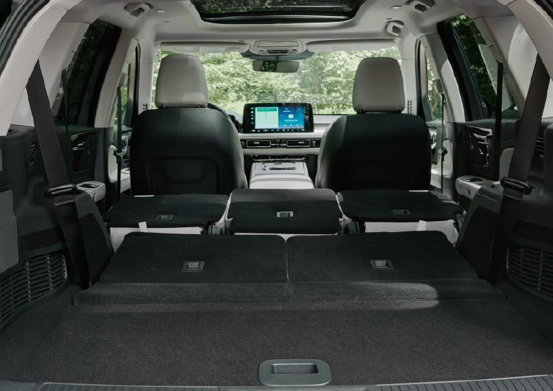 A rear to front view of the interior of a 2027 Lincoln Aviator® Black Label™ SUV shows the third and second rows folded flat | Boulevard Lincoln in Millsboro DE