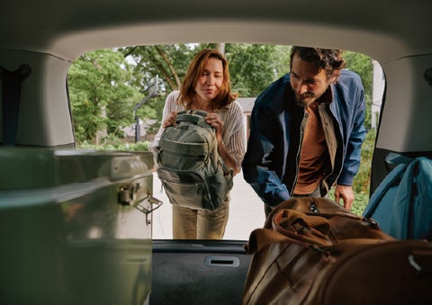 A couple loads luggage into the rear of a 2027 Lincoln Aviator® Black Label™ SUV..e 202 | Boulevard Lincoln in Millsboro DE
