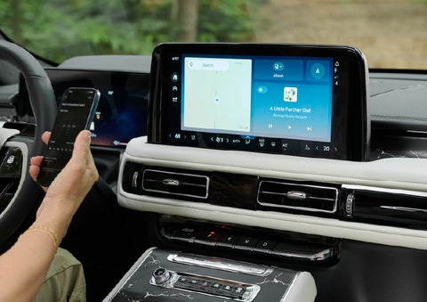 A person pairs thier phone with the center touchscreen of a 2027 Lincoln Aviator® Black Label™ SUV | Boulevard Lincoln in Millsboro DE